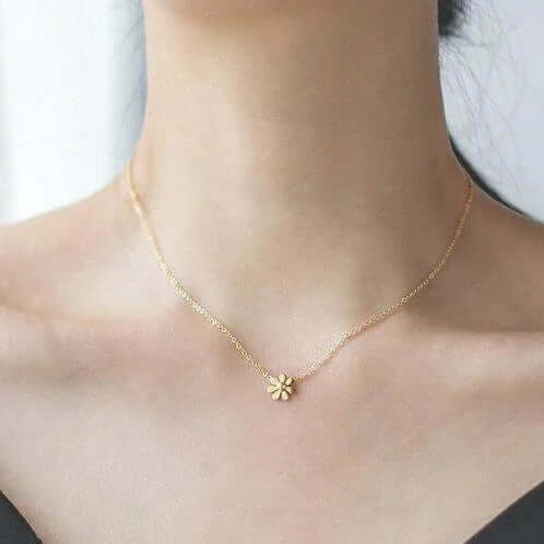 Delicate gold flower pendant necklace on woman's neck, Ceyrah jewelry photography
