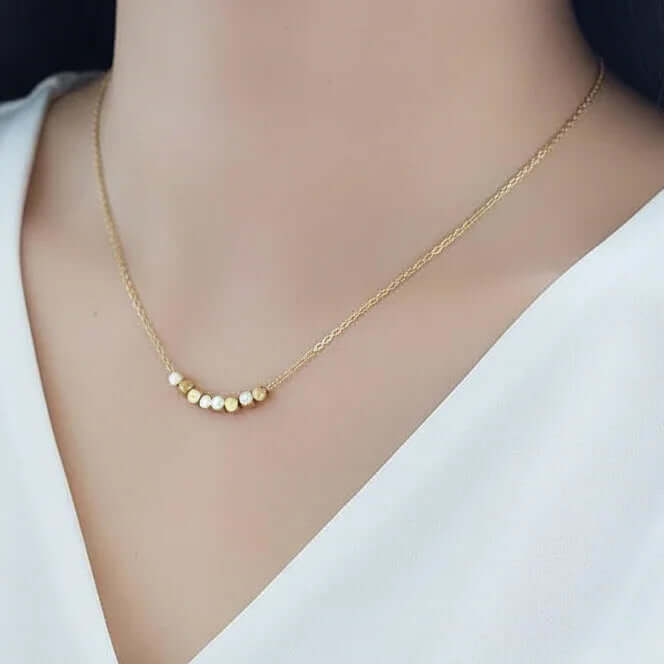 Dainty Square Gold Necklace showcased on a model, featuring geometric gold segments on a delicate chain.