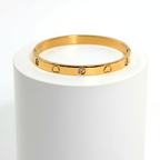 Heart Engraved Bangle Bracelet gold on white pedestal 