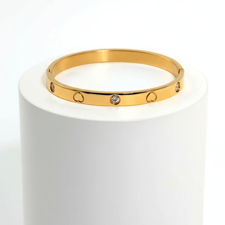 Heart Engraved Bangle Bracelet gold on white pedestal 