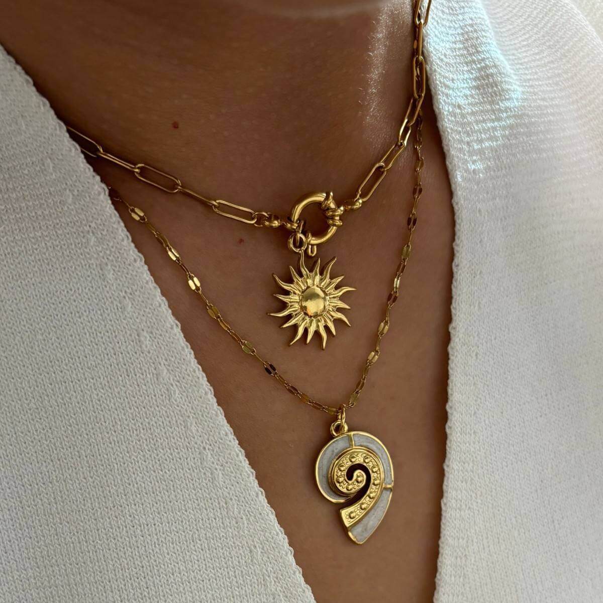 Gold Conch Shell Pendant Necklace layered with sun pendant on a delicate gold chain.