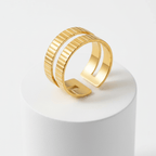 Gold Textured Double Band Ring on a display pedestal, showcasing its modern design and luminous finish.