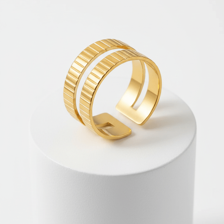 Gold Textured Double Band Ring on a display pedestal, showcasing its modern design and luminous finish.