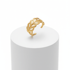 Adjustable Gold Leaf Ring displayed on a white pedestal, featuring a sculpted leaf design and an open-band silhouette.