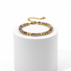 Gold Colour Gemstone Bracelet with jewel-tone beads on a display stand.