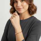 Woman showcasing a Gold Bamboo Bangle Bracelet on her wrist, highlighting its elegant and minimalist design.