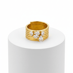 Stacked Gold Teardrop Ring featuring multiple gold bands and clear teardrop gemstones, showcasing modern elegance.