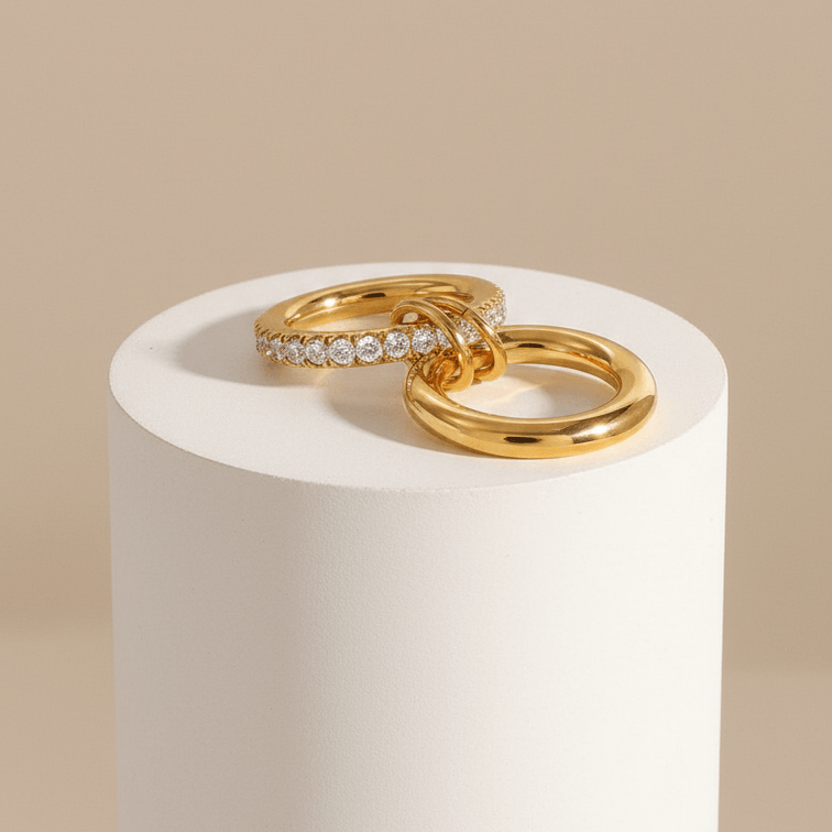 Double Layered Gold Gemstone Ring featuring polished gold band and clear stones on a minimal pedestal.