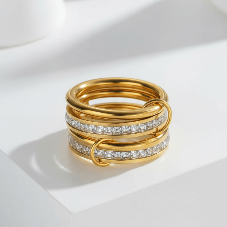 Four Layered Gold Eternity Ring featuring polished bands and square-cut clear stones.