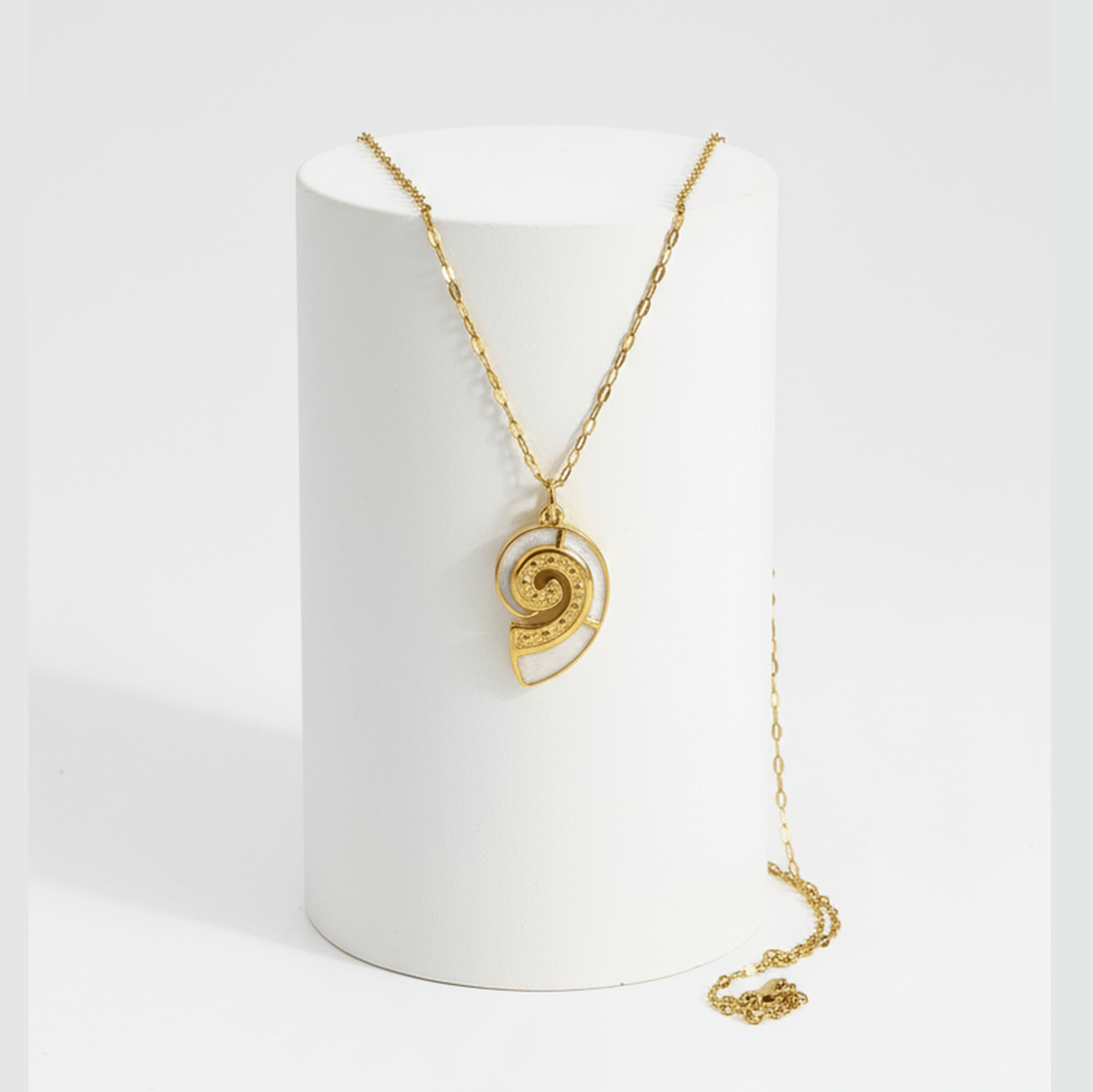 Gold Conch Shell Pendant Necklace displayed on a stand, showcasing its spiral design and elegant gold finish.