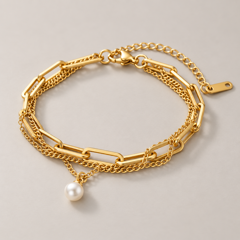 A Layered Paperclip Chain Pearl Charm Bracelet with a single white pearl pendant, displayed on a neutral light gray background.
