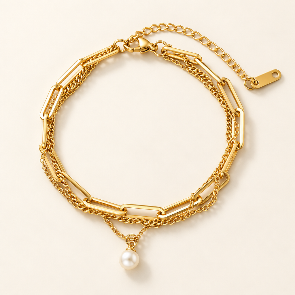 A gold-toned Layered Paperclip Chain Pearl Charm Bracelet, displayed on a clean off-white background.