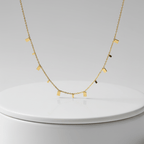 Mini Gold Bar Charm Necklace on pedestal