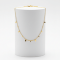 Mini Gold Bar Charm Necklace on white pedestal