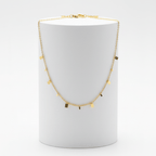 Mini Gold Bar Charm Necklace on white pedestal