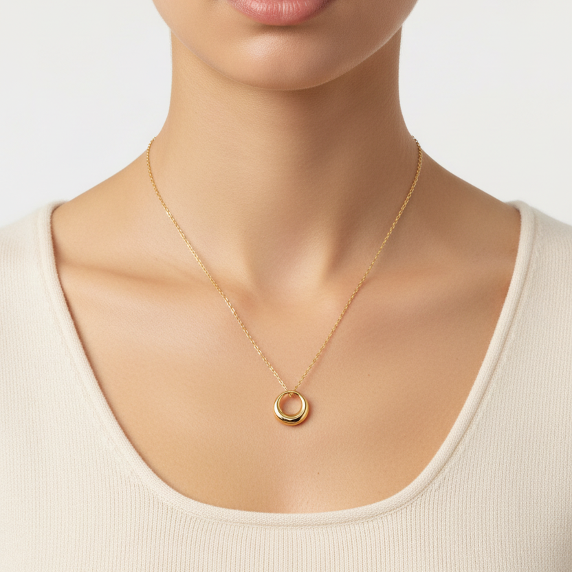 A close-up of a model's wearing a Mini Gold Circle Pendant Necklace 