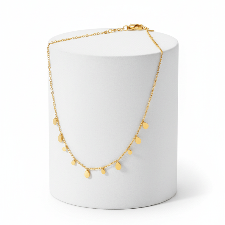 Mini Teardrop Charm Necklace on round white pedestal 