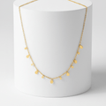 Mini Teardrop Charm Necklace on pedestal