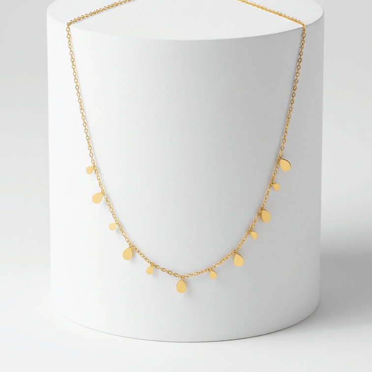 Mini Teardrop Charm Necklace on pedestal