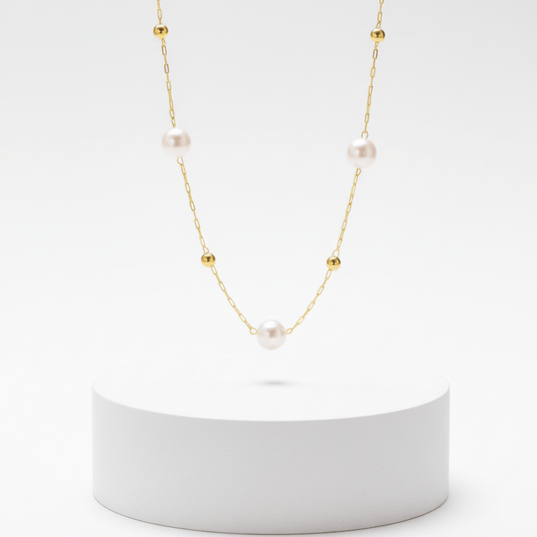 Minimal Pearl Station Necklace on over white platform