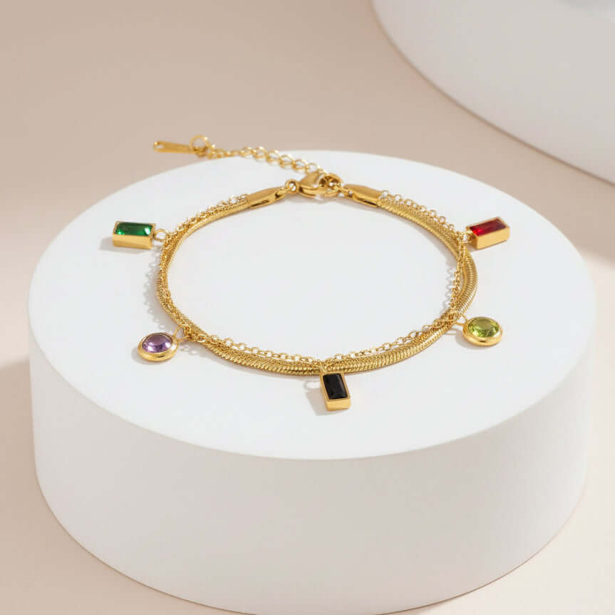 Multi-Charm Chain Bracelet with colorful gemstones on a white background
