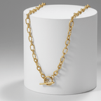 OT Clasp Chain Necklace Gold on white pedestal with grey background 