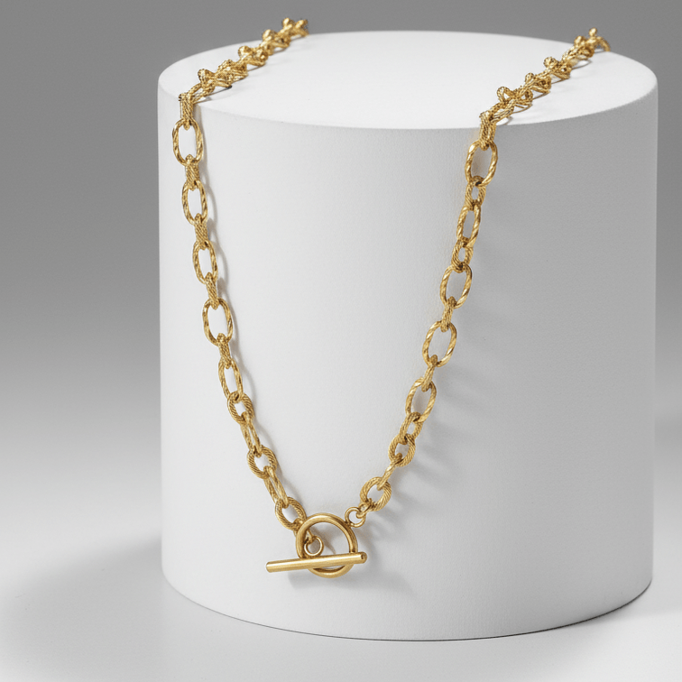 OT Clasp Chain Necklace Gold on white pedestal with grey background 