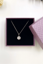 Gift Box with Necklace featuring a sparkling white diamond pendant on a silver chain inside elegant packaging.