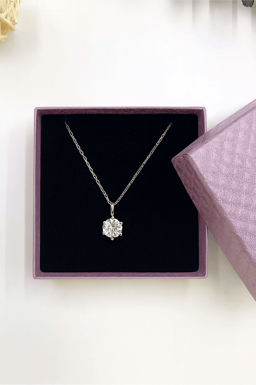 Gift Box with Necklace featuring a sparkling white diamond pendant on a silver chain inside elegant packaging.