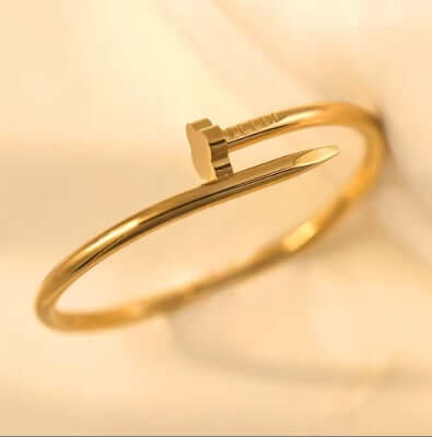 Clover Nail Bangle Bracelet in sleek silver finish, showcasing modern design and elegant style on a display.