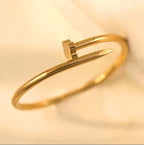 Clover Nail Bangle Bracelet in sleek silver finish, showcasing modern design and elegant style on a display.