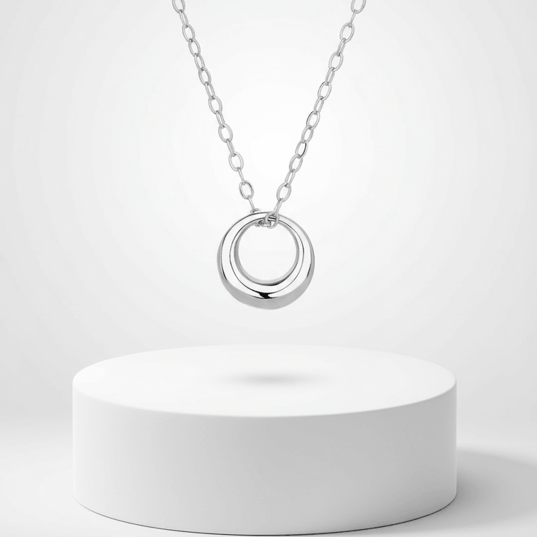 Mini Gold Circle Pendant Necklace hanging on a delicate chain, showcasing its modern style and elegant simplicity.