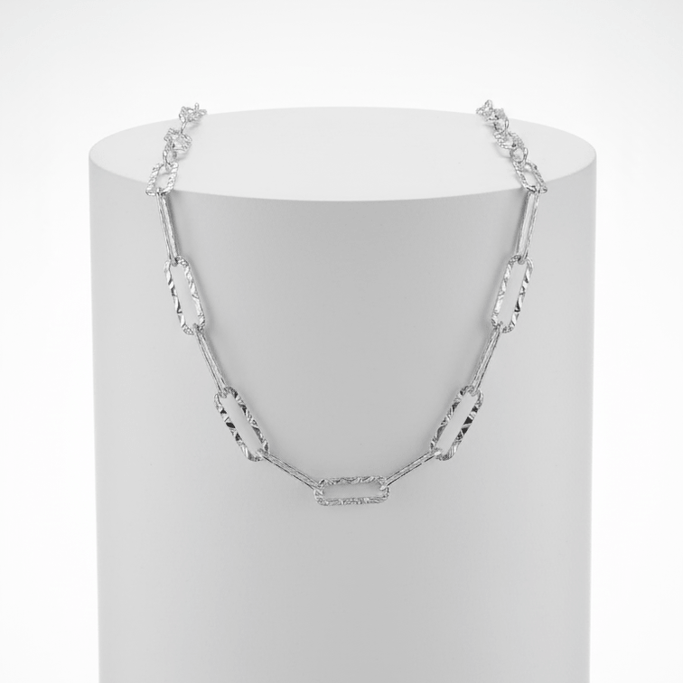 Silver Paperclip Chain Necklace on white pedestal 