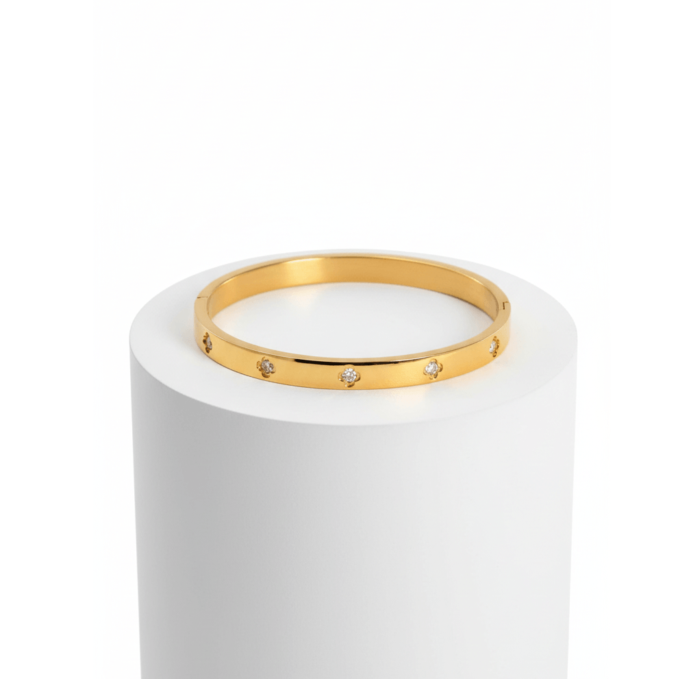 Small Clover Bangle Bracelet gold on white pedestal