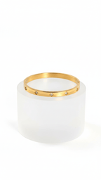 Small Clover Bangle Bracelet on white round pedestal