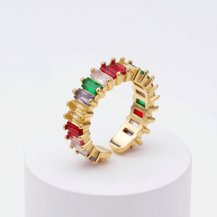 Spectrum Baguette Eternity Ring with colorful gemstones on a white pedestal