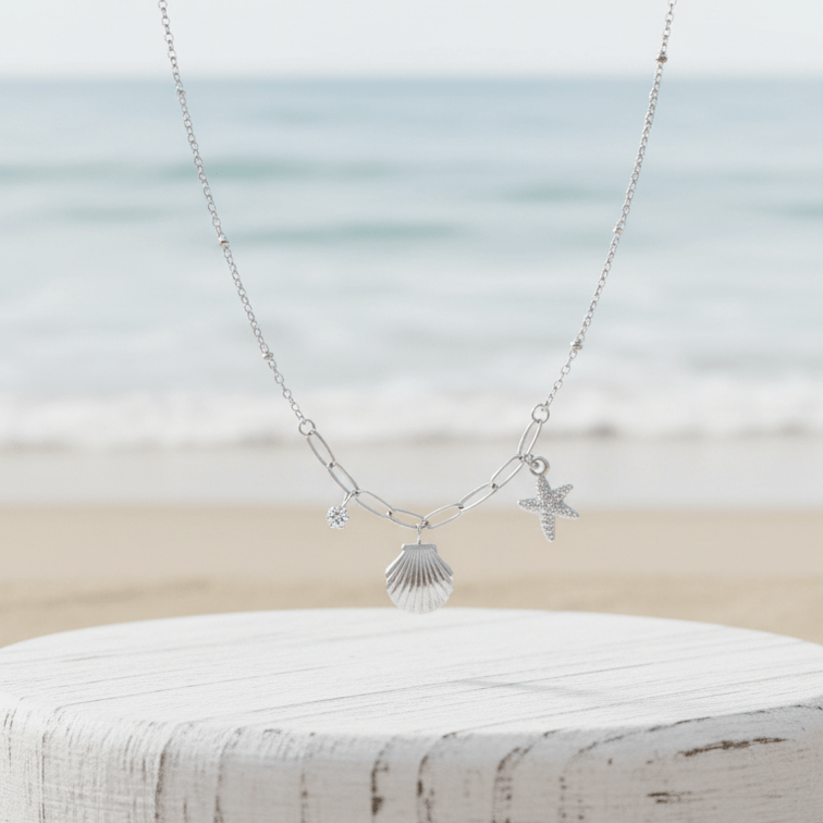 Starfish Shell Necklace Silver on pedestal beach background
