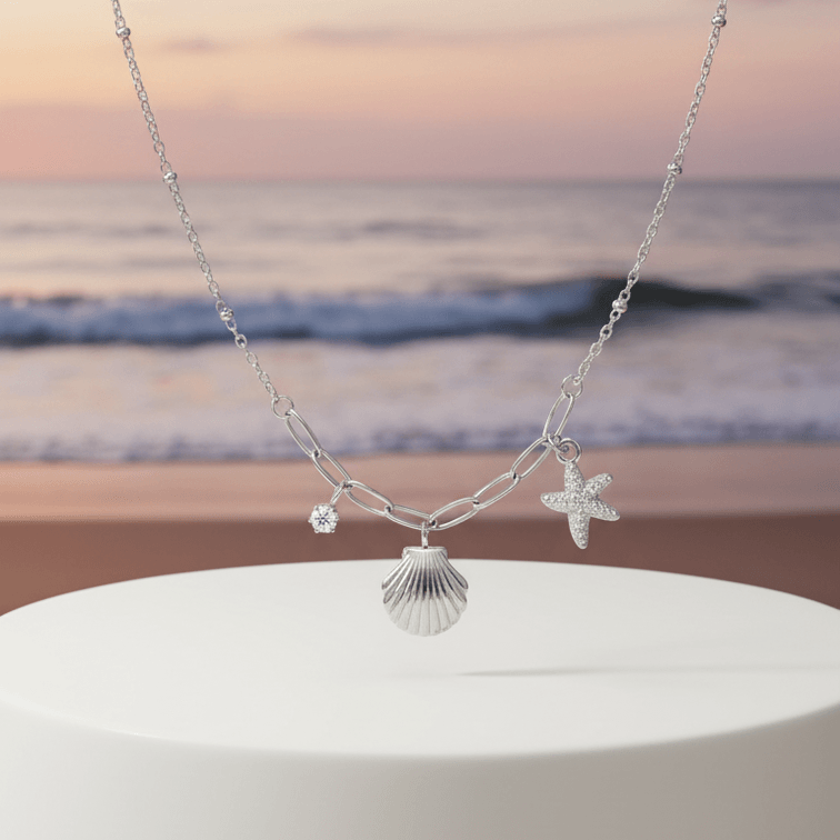 Starfish Shell Necklace Silver on pedestal beach background