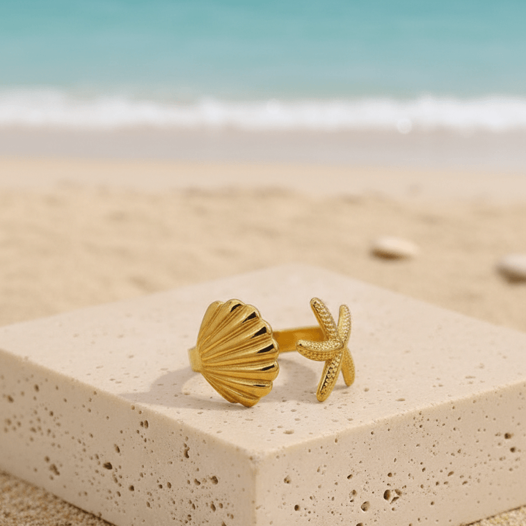 Starfish_Shell_Open_Ring_Gold_004 on a stone block with a beach background