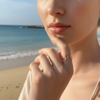 Close-up of a woman's hand with a Starfish & Shell Open Ring Gold on a beach.