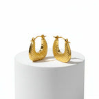 Textured Gold Crescent Hoop Earrings on stone