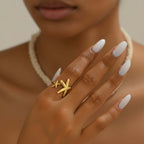 Twin Starfish Open Gold Ring on a hand with a neutral background