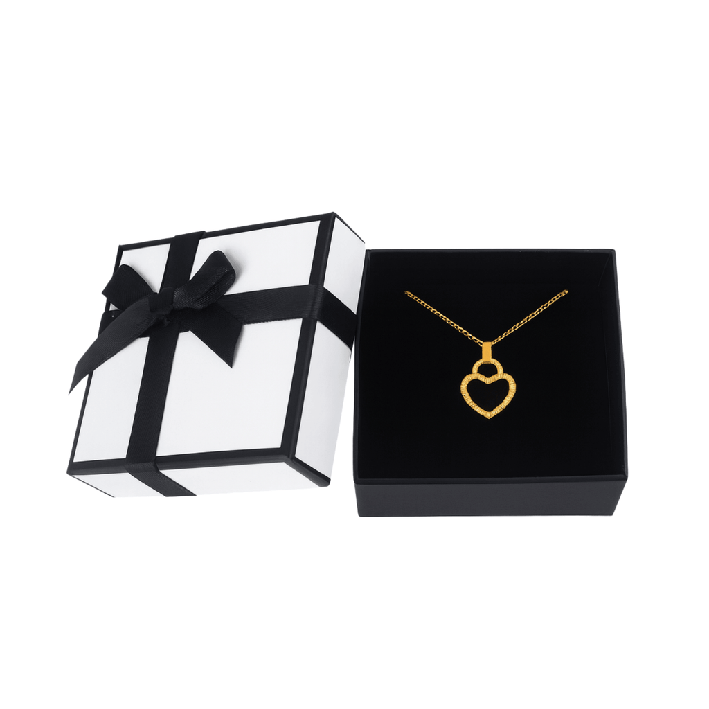 Gold heart pendant necklace in black jewelry box with white gift box and black ribbon