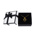 Gold heart pendant necklace in black jewelry box with white gift box and black ribbon