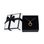 Gold heart pendant necklace in black jewelry box with white gift box and black ribbon