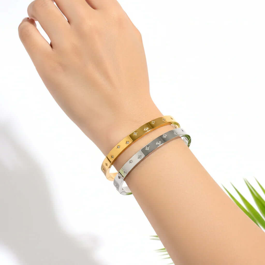 Ceyrah gold and silver Zirconia Embedded Star Bangle Bracelet on wrist on white background