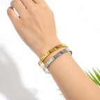 Ceyrah gold and silver Zirconia Embedded Star Bangle Bracelet on wrist on white background