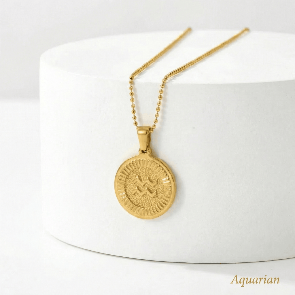 Zodiac Sign Medallion Necklace Gold  with a round pendant on a white surface, labelled 'Aquarian'.