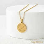 Zodiac Sign Medallion Necklace Gold with Sagittarius sign on a white surface