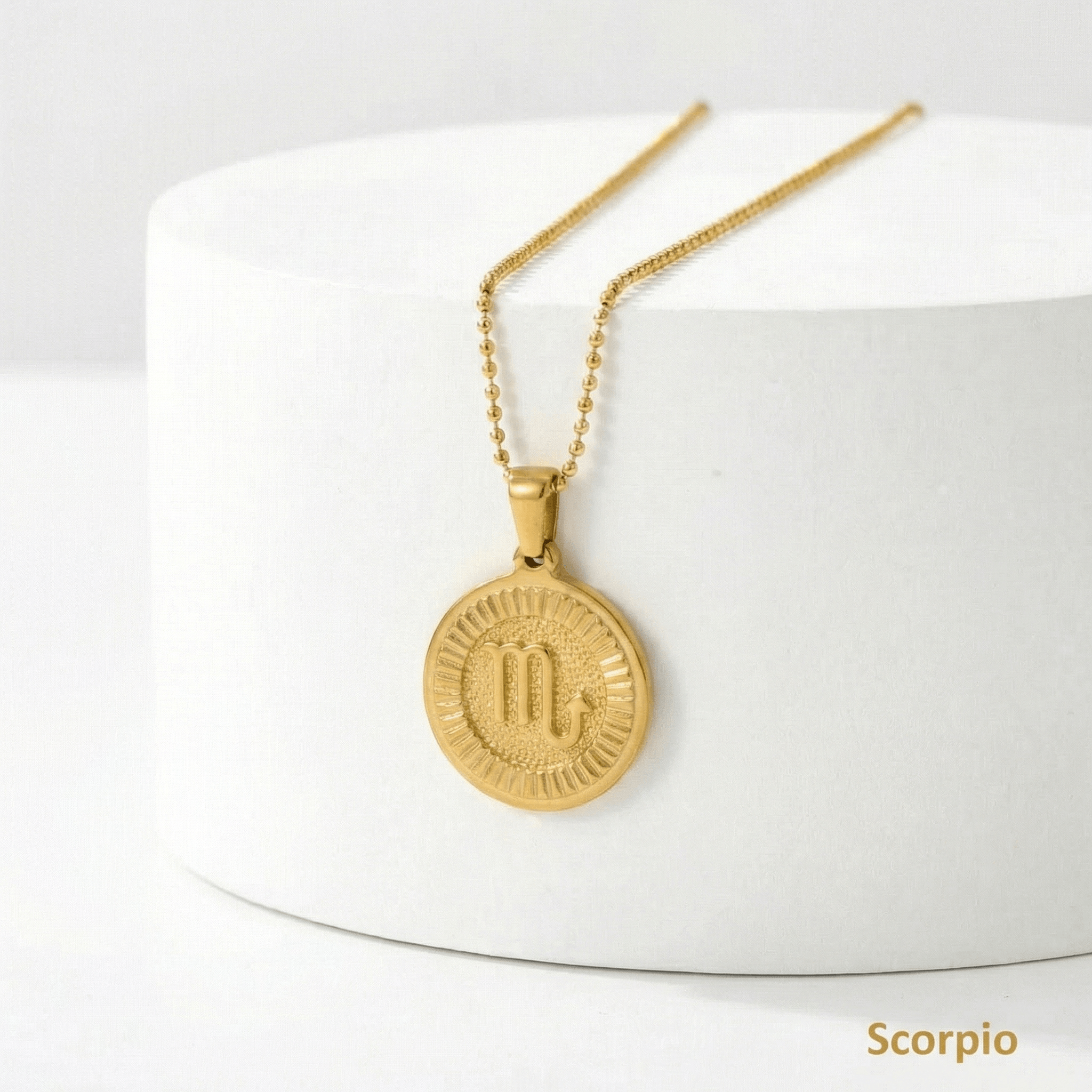 Zodiac Sign Medallion Necklace Gold with a Scorpio pendant on a white surface